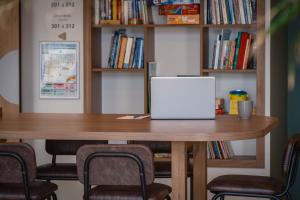 a laptop computer sitting on top of a wooden table at L'Escale Marine, The Originals Relais in Crozon