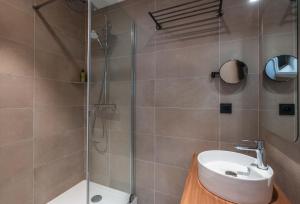 a bathroom with a shower and a sink and a toilet at L'Escale Marine, The Originals Relais in Crozon