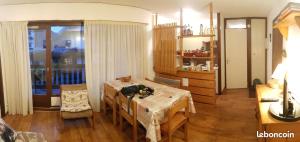 a living room with a table and a dining room at Montagne aux Contamines Montjoie Appartement 6-7 personnes in Les Contamines-Montjoie