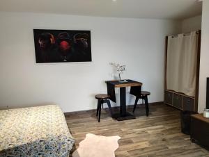 a room with a bed and a table with a desk at Studio à Bellegarde in Bellegarde