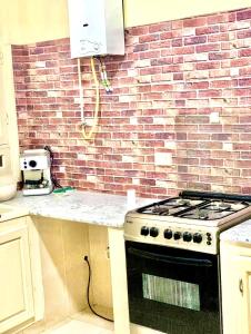 a kitchen with a stove and a brick wall at Holiday home by the sea, Gabes in Gabès