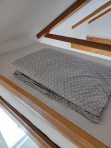 a mattress on top of a bunk bed at The little White House in Sibiu