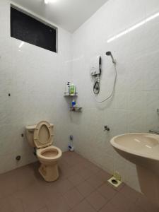 a bathroom with a toilet and a sink at DIY Palm Court Bedroom in Kuantan