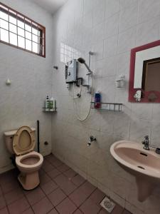 a bathroom with a toilet and a sink at DIY Palm Court Bedroom in Kuantan
