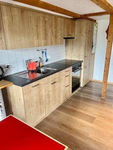 a kitchen with a sink and a counter top at Chalet Sonnenheim, Wohnung mit Panoramafenster in Adelboden