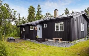 a black tiny house with a bench in a yard at Beautiful Home In Gol With 3 Bedrooms in Gol