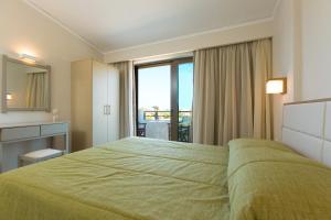 A bed or beds in a room at Trefon Hotel Apartments and Family Suites