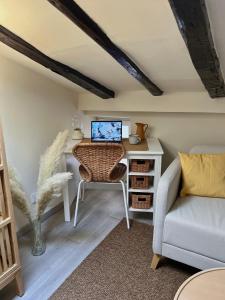 a room with a desk with a computer and a couch at Charming apartment in the heart of Madrid in Madrid