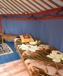 a bed in a room with a blue tent at Nature Door Resort, Khuvsgul province, Mongolia 