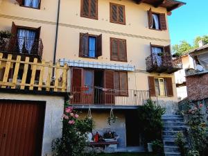 a large building with balconies and stairs in front of it at La casa di Elma in Brosso