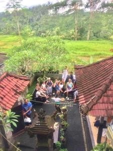 a group of people sitting on the floor of a house at Twin Inn in Ubud