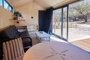 a living room with a table and a couch at Clarens 'Gazza' Pod in Clarens