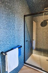 a bathroom with a glass shower with a towel at Clarens 'Gazza' Pod in Clarens