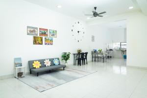 a living room with a couch and a table at 5 stars Rawang homestay in Rawang