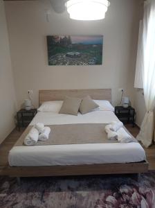 a bedroom with a large bed with towels on it at Monolocale Lucca PellegriniLittleHouse in Lucca