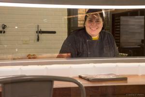 a woman standing behind a counter in a kitchen at Momora distrito selva in Santa Ana +116 photos