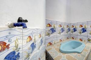 a bathroom with a blue toilet in the corner at SPOT ON 92906 Surya Indah Homestay Syariah in Mojokerto