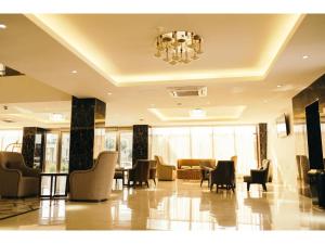 卢萨卡Grand Palace Hotel Lusaka的大厅里摆放着桌椅和枝形吊灯