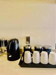 a group of coffee cups on a tray on a counter at Moc Luxury Apartment in Johannesburg