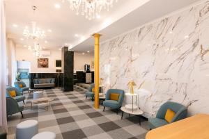 a waiting room with blue chairs and a marble wall at Lisboa 85 Suites & Apartments by RIDAN Hotels in Lisbon