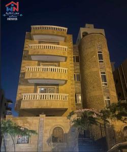a tall building with balconies on the side of it at Two million hotel 2 in 6th Of October