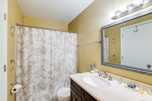 a bathroom with a sink and a shower curtain at Anchorage Home about 7 Mi to Chugach State Park! in Anchorage +16 photos