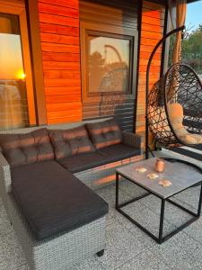 a couch and a table on the porch of a house at Mobile Home L&L in Drage