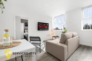 a white living room with a couch and a table at SCA- Arden Apartment 4 Twin Bedroom Free Parking in Coventry