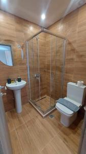 a bathroom with a shower and a toilet and a sink at Unique Experience Apartment’s in Thessaloniki