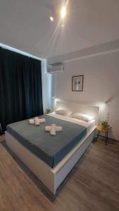 a bedroom with a large bed with two pillows at Unique Experience Apartment’s in Thessaloniki
