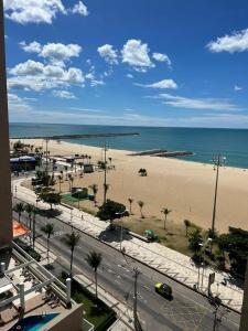 a view of a beach and the ocean from a building at Terraços do Atlântico - Apto Beira Mar Fortaleza in Fortaleza