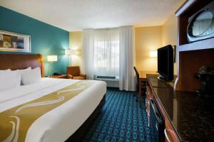 a hotel room with a large bed and a television at Quality Inn & Suites Bozeman in Bozeman