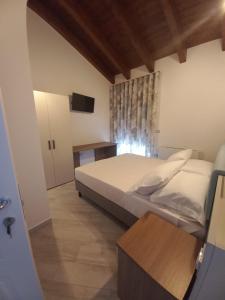 a bedroom with a bed and a television in it at Il Riccio home & relax in Riccia
