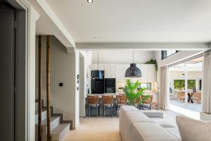 a living room with a couch and a kitchen at Troia Villas in Bali