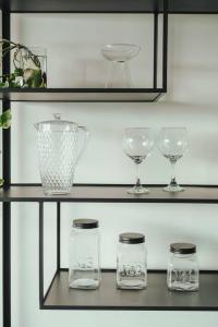 a shelf with glasses and a vase on it at Mansion Botánico Premium Buenos Aires in Buenos Aires
