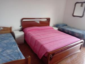 a bedroom with a bed and two trunks at Villetta Alberti in Sanremo