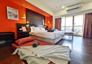 - une chambre d'hôtel avec 2 lits et des murs orange dans l'établissement Sunway Lagoon Sweet Comfy Home for 1-5pax, à Petaling Jaya