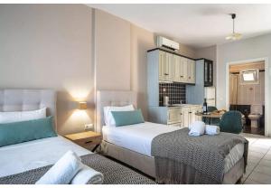 Un dormitorio con dos camas y una cocina. en Sunset Triple 2, en Agios Nikitas 10 fotos más