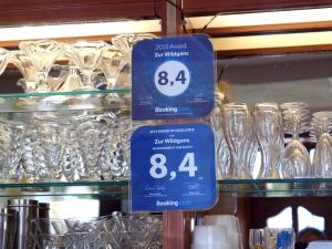 a couple of blue signs on a shelf with glasses at Zur Wildgans in Arendsee