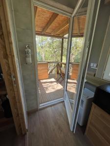 a room with a door leading to a deck at Chalet dans les arbres in Nice