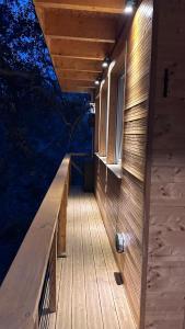 a wooden porch of a house with a window at Chalet dans les arbres in Nice