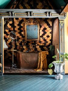 a bath tub in a room with a wall at Private and chique Salon de Franz - with large terrace in Amsterdam