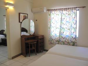 A bed or beds in a room at Capital Hotel