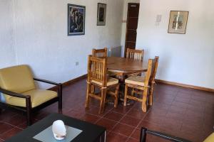 a dining room with a wooden table and chairs at CERCA DE TODO amplio in Mendoza