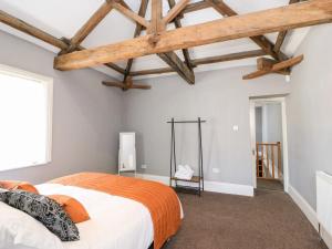a bedroom with a large bed and wooden ceilings at St John's North Hotel Apartments in Wakefield