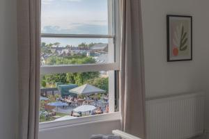 una ventana con vistas a la playa desde una habitación de hotel en Fabulous, vibrant, town house, central Bath Road en Cheltenham