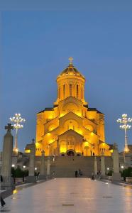 a large building with a tower at night at Erik in in Tbilisi City