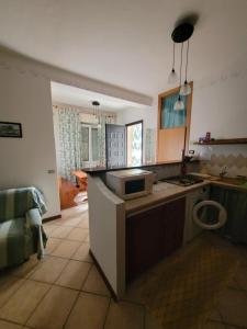 a kitchen with a sink and a counter top at Appartamento al piano terra a Gabbice mare per grande compania in Gabicce Mare