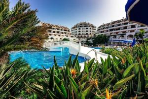 a resort with a swimming pool and some buildings at Cozy seaside apartment 215 in Parque Santiago 2 in Playa de las Americas