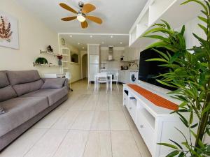 a living room with a couch and a kitchen at Cozy seaside apartment 215 in Parque Santiago 2 in Playa de las Americas